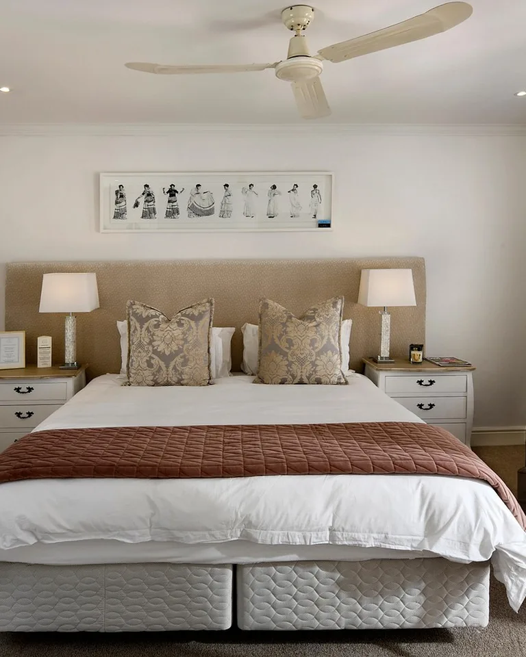 Tidy small bedroom with a bed, nightstand, and organized storage