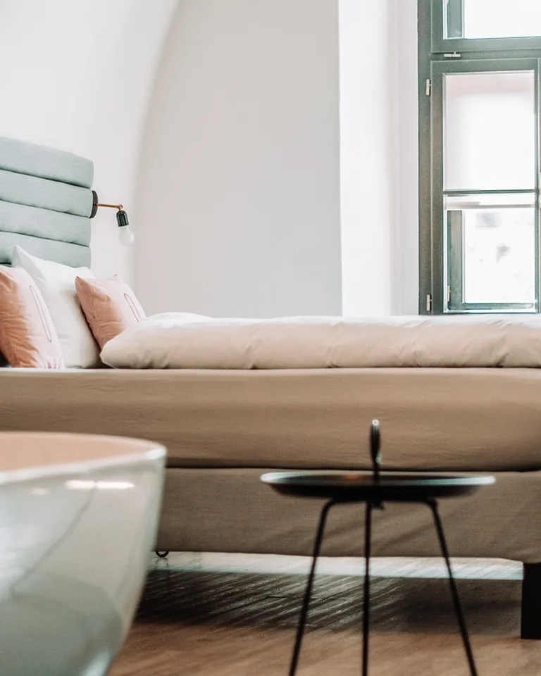Cozy apartment bedroom with a neatly made bed and warm lighting