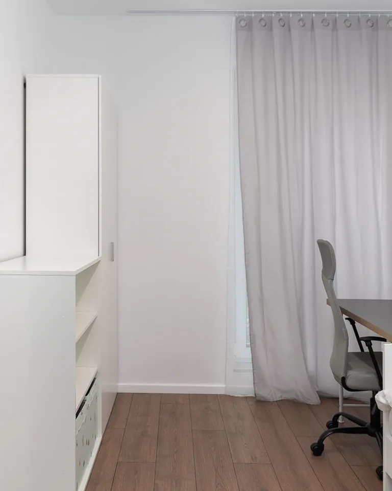 Small desk workspace tucked into a bedroom corner nook