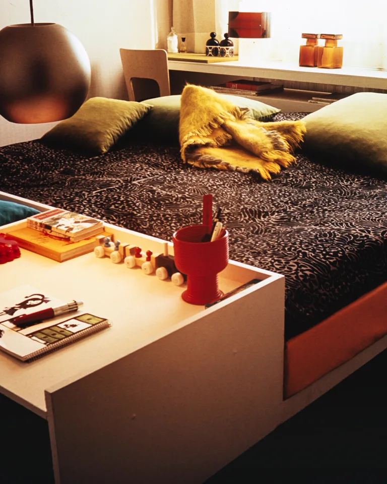 Bedroom with a bed and desk combined into one wall unit