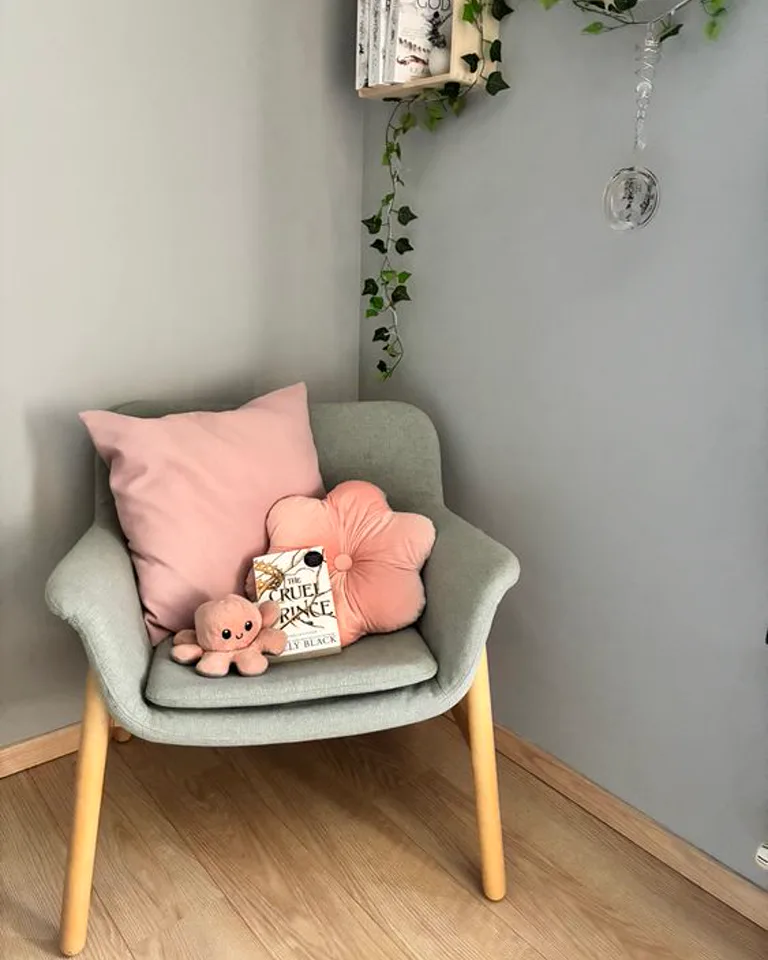 Armchair reading nook tucked into a bedroom corner