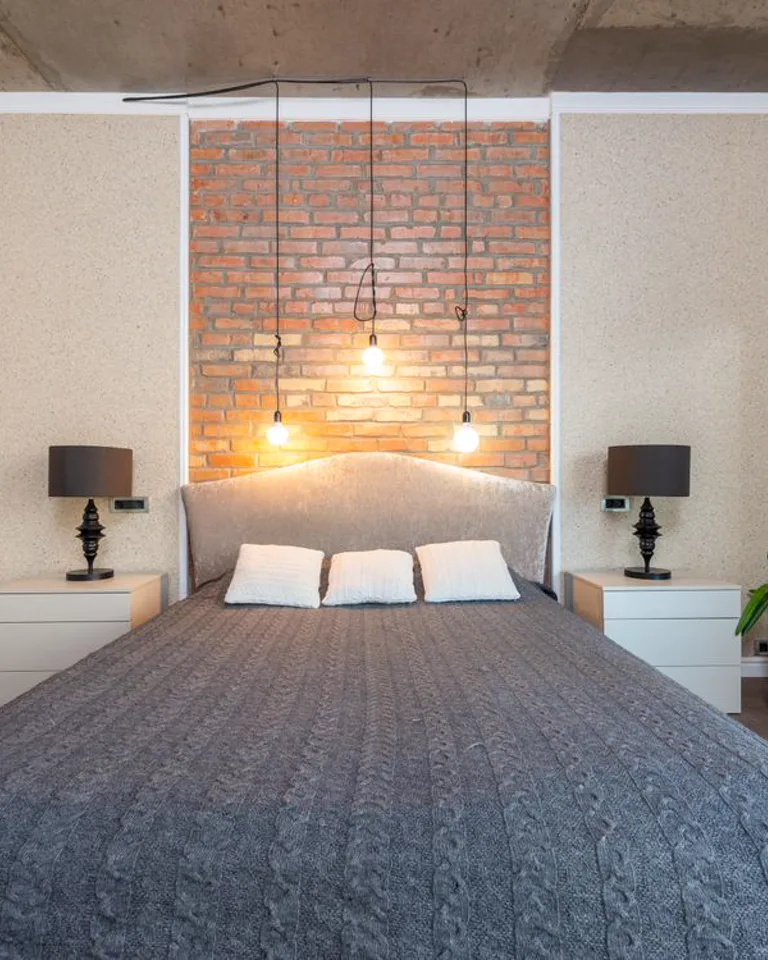 Bedroom with a large ornate mirror leaning against the wall
