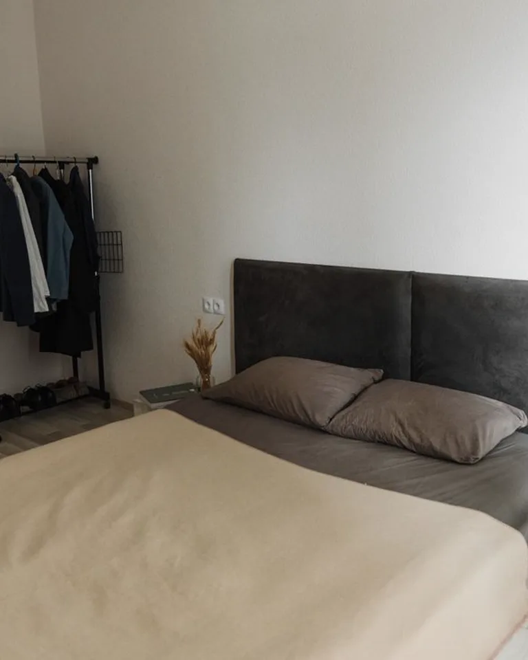 Clothes hanging on a bedroom clothing rack