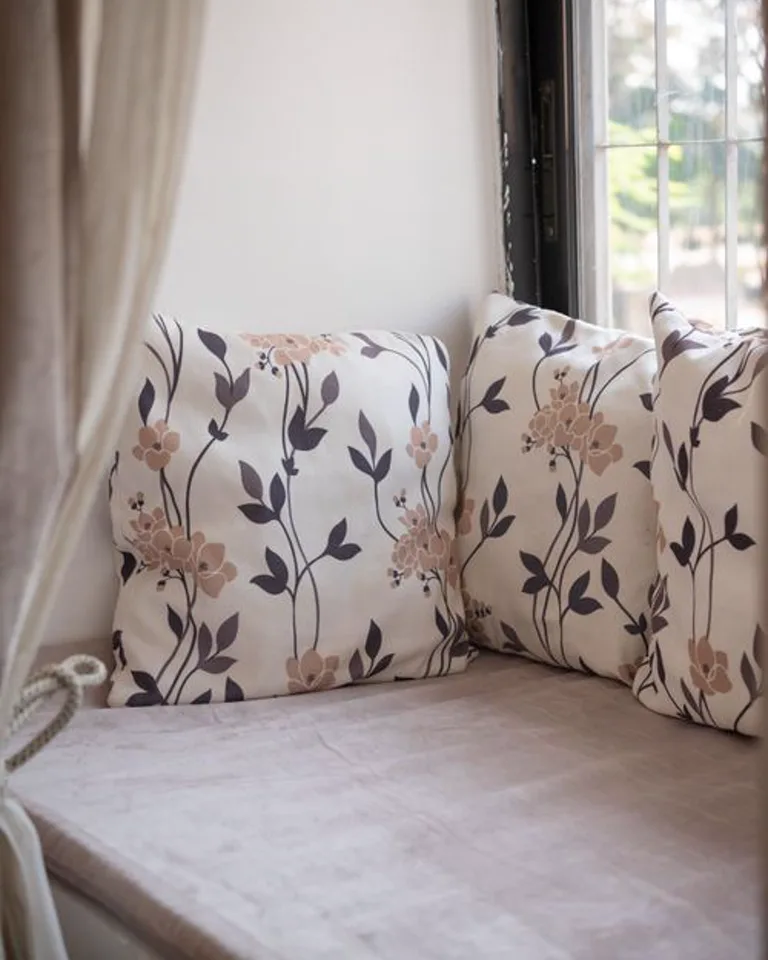 Cozy window seat with cushions in a bedroom dormer