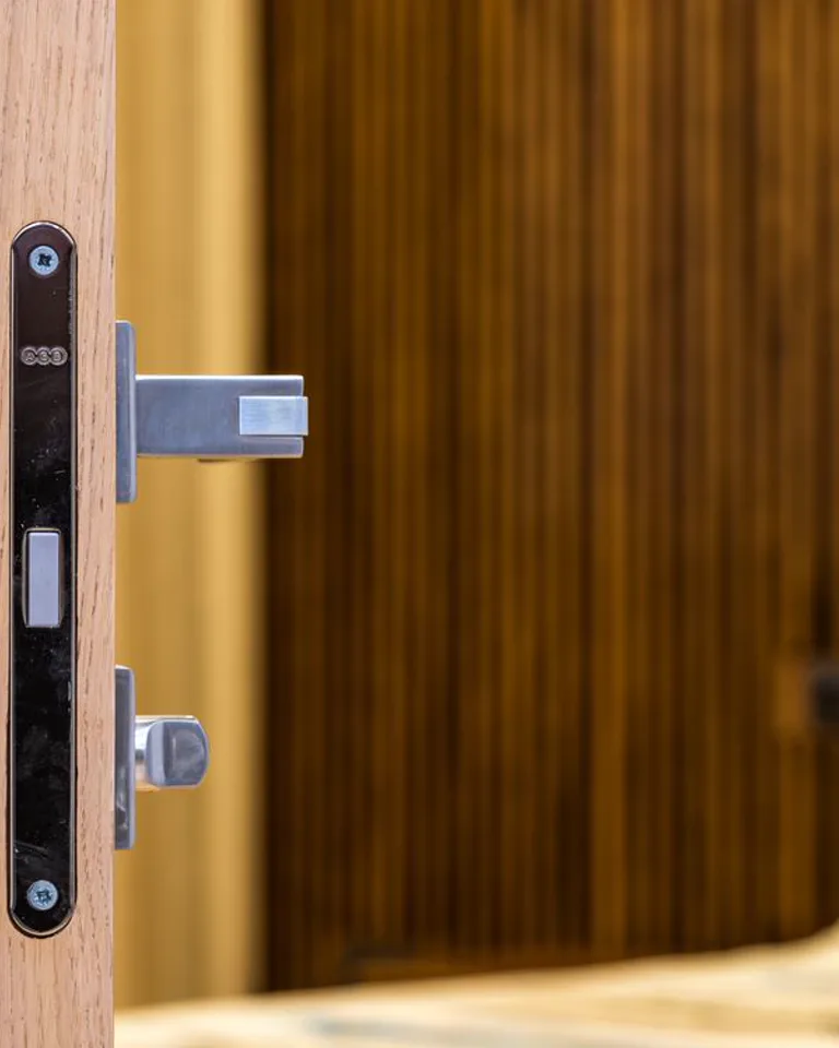 Bedroom door with a wooden frame and handle