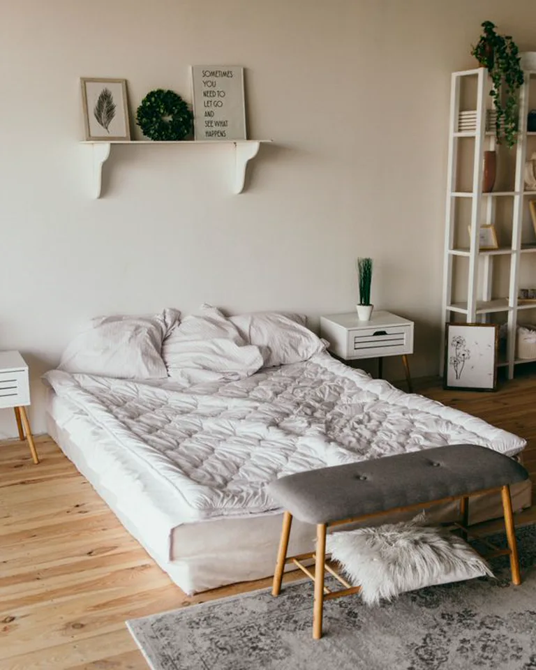 Storage bench at the foot of a bed in a bedroom