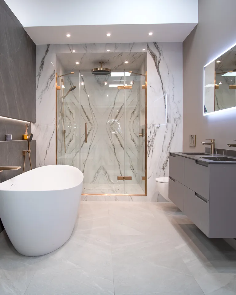 Luxury bathroom with backlit mirror and freestanding tub