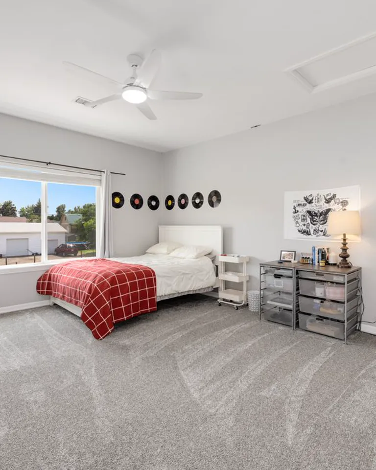 Spacious bedroom with a bed and large open floor area