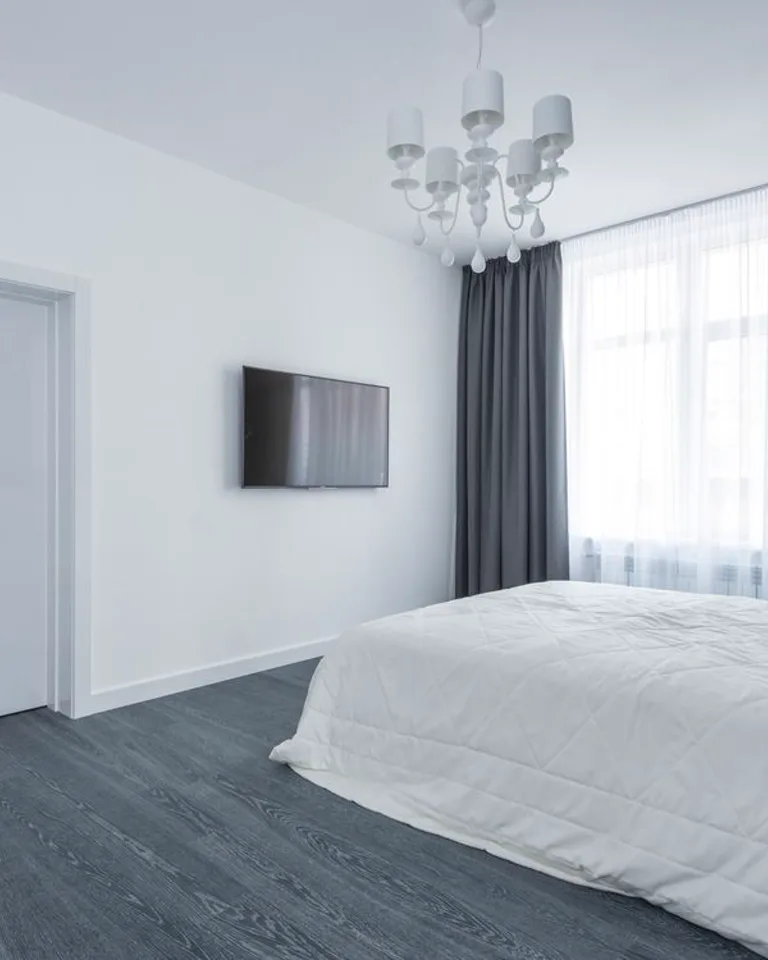 Bed in a bedroom with the door and walkway kept clear