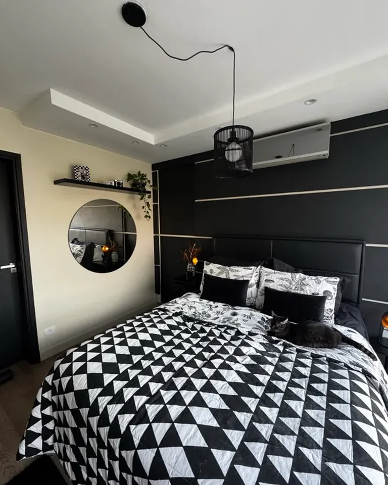 Bedroom with white walls, black furniture and neutral accents