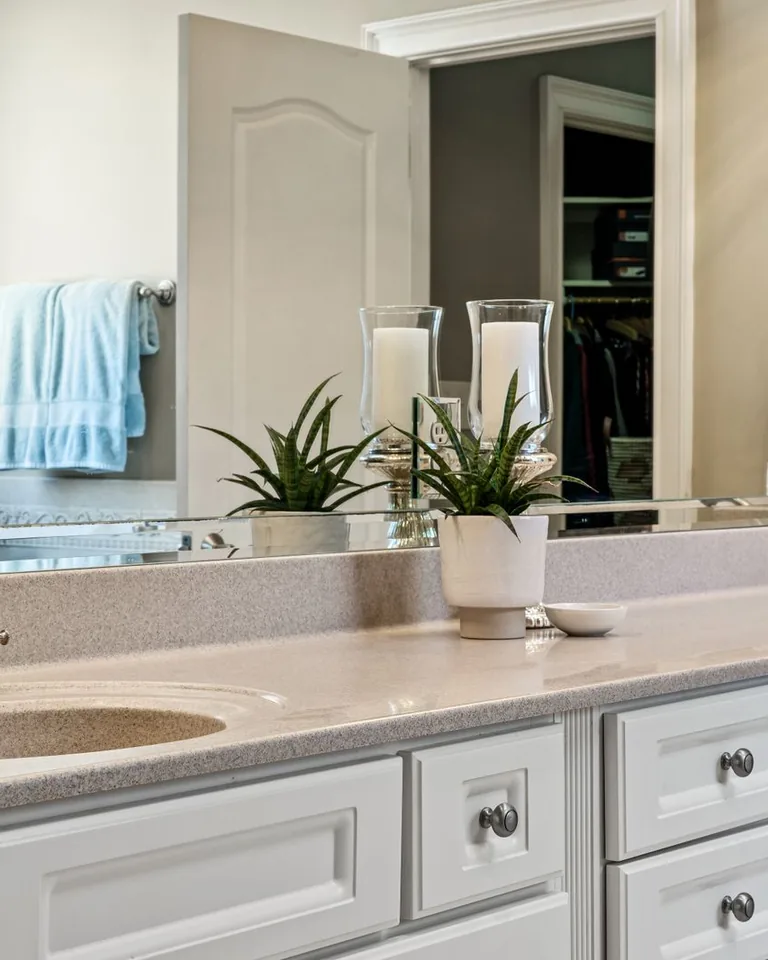 Minimalist neutral bathroom with white vanity cabinets