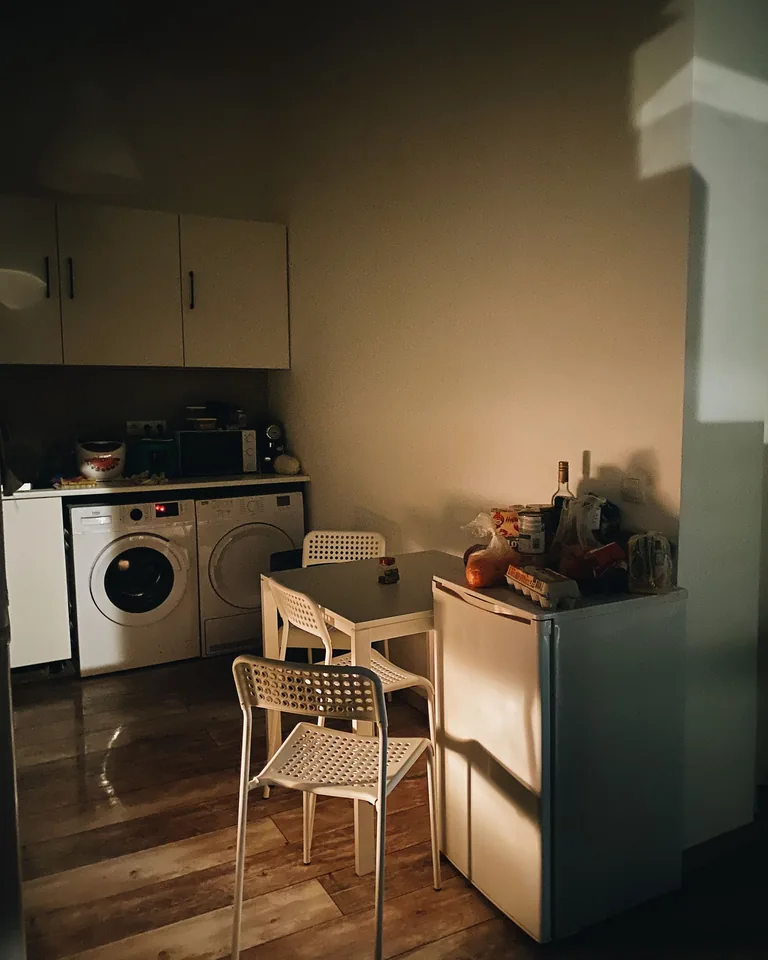 Warm sunlight illuminating a small apartment kitchen