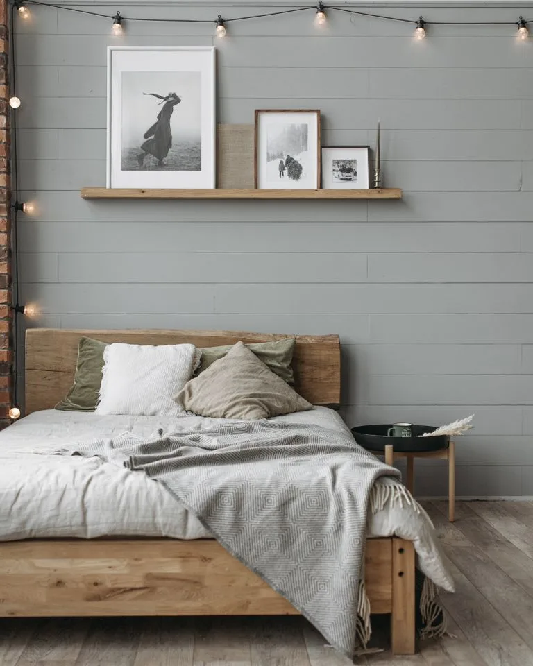 Farmhouse bedroom decorated in warm neutrals with layered textiles