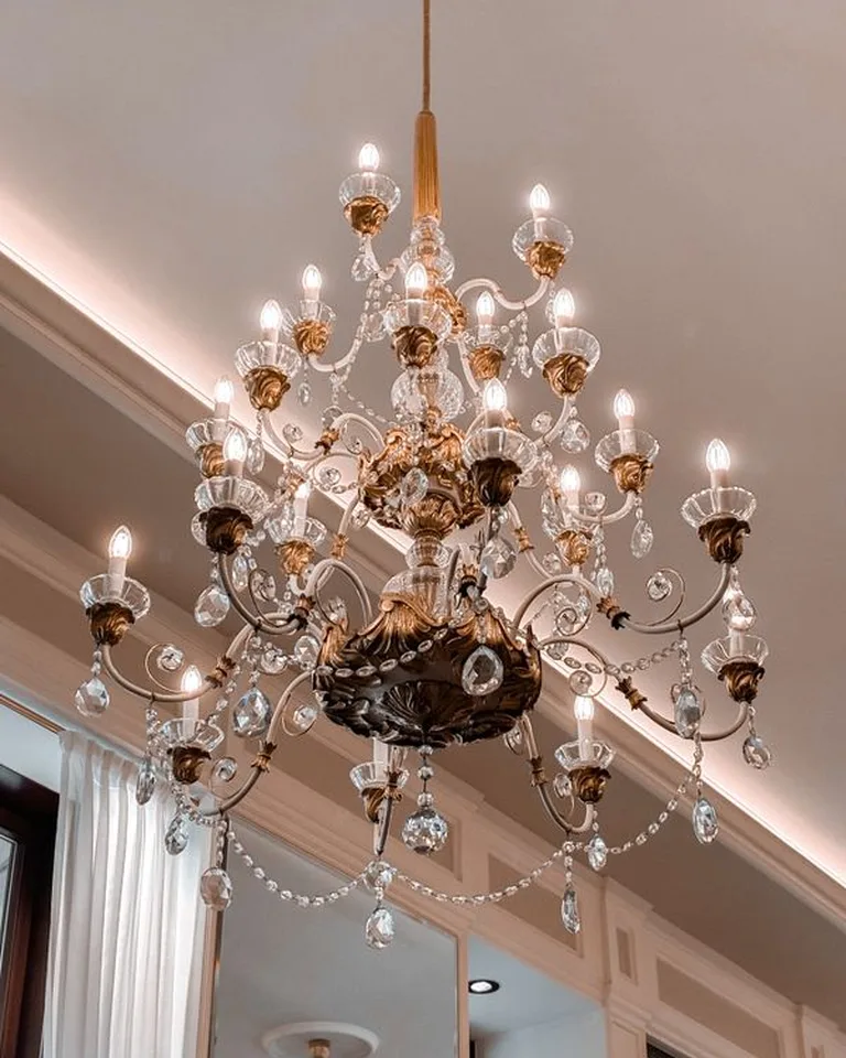 Crystal chandelier hanging in an elegant French-style bedroom