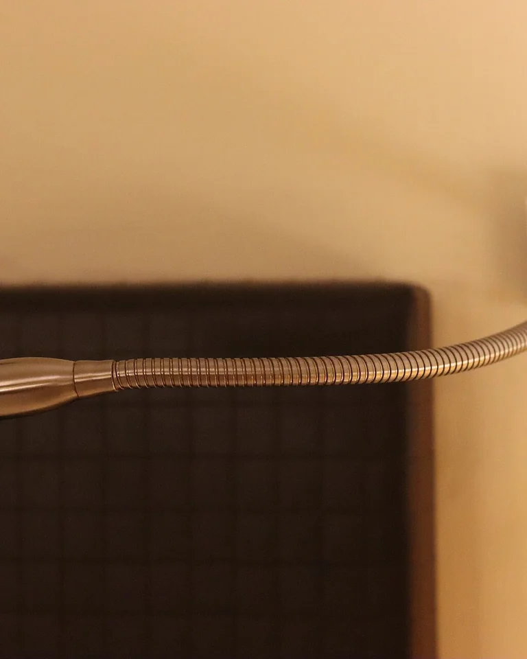 Bedside lamp casting a warm glow across a cozy bedroom at night
