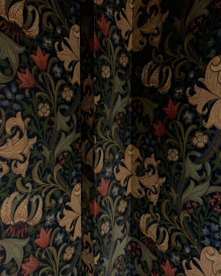 Dark botanical floral wallpaper bringing drama to a bathroom wall