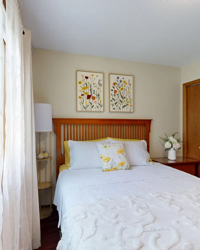 Bright small bedroom with wooden furniture and a wardrobe using space efficiently