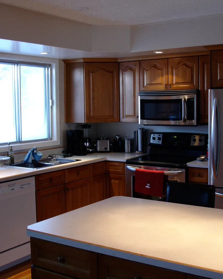 Warm wood kitchen cabinets with white countertops
