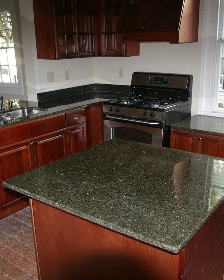 Kitchen with warm wood cabinets and a stone-topped island