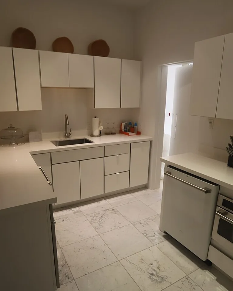 Modern white kitchen with sleek flat-panel cabinets