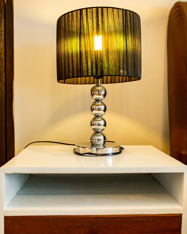 Bedside table lamp with a warm-toned shade
