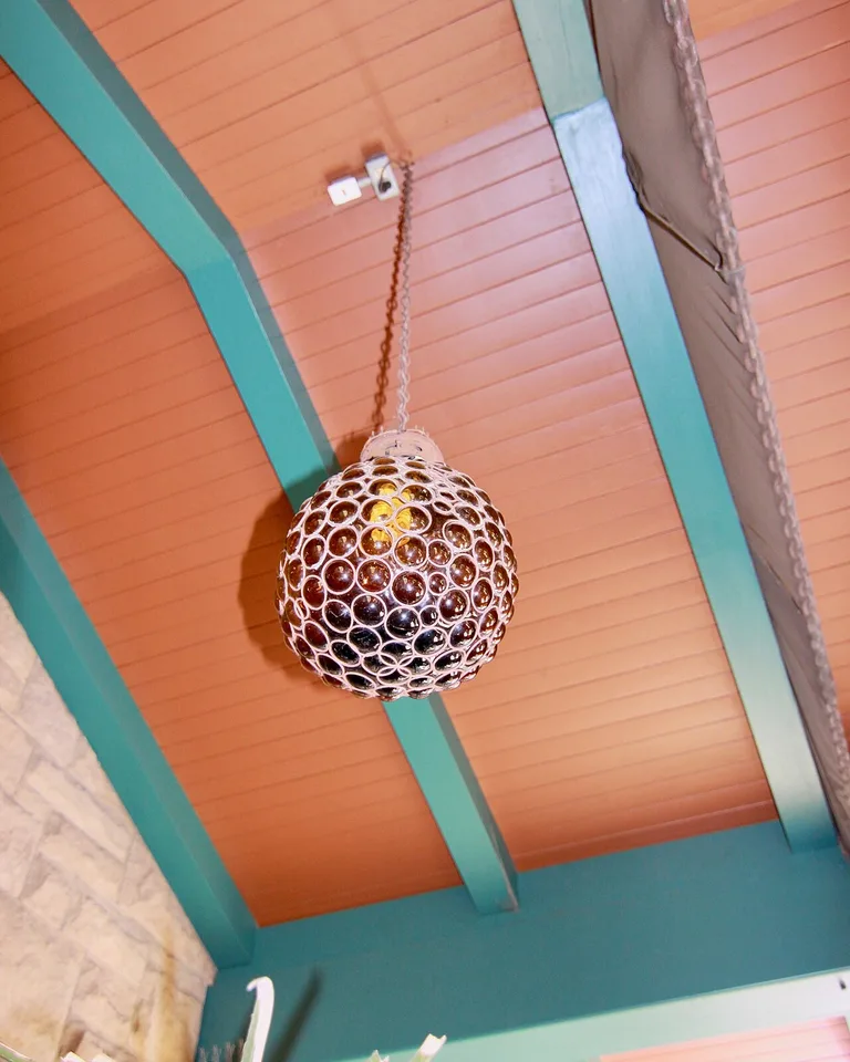 Amber glass globe pendant light glowing warmly