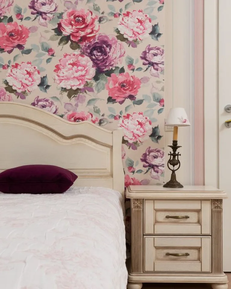 Floral peel-and-stick wallpaper accent wall behind a bed