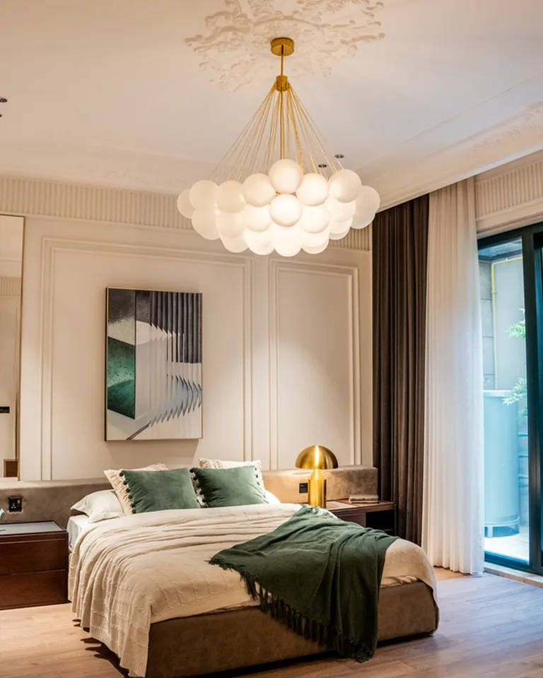 Small crystal chandelier hanging over a bedroom