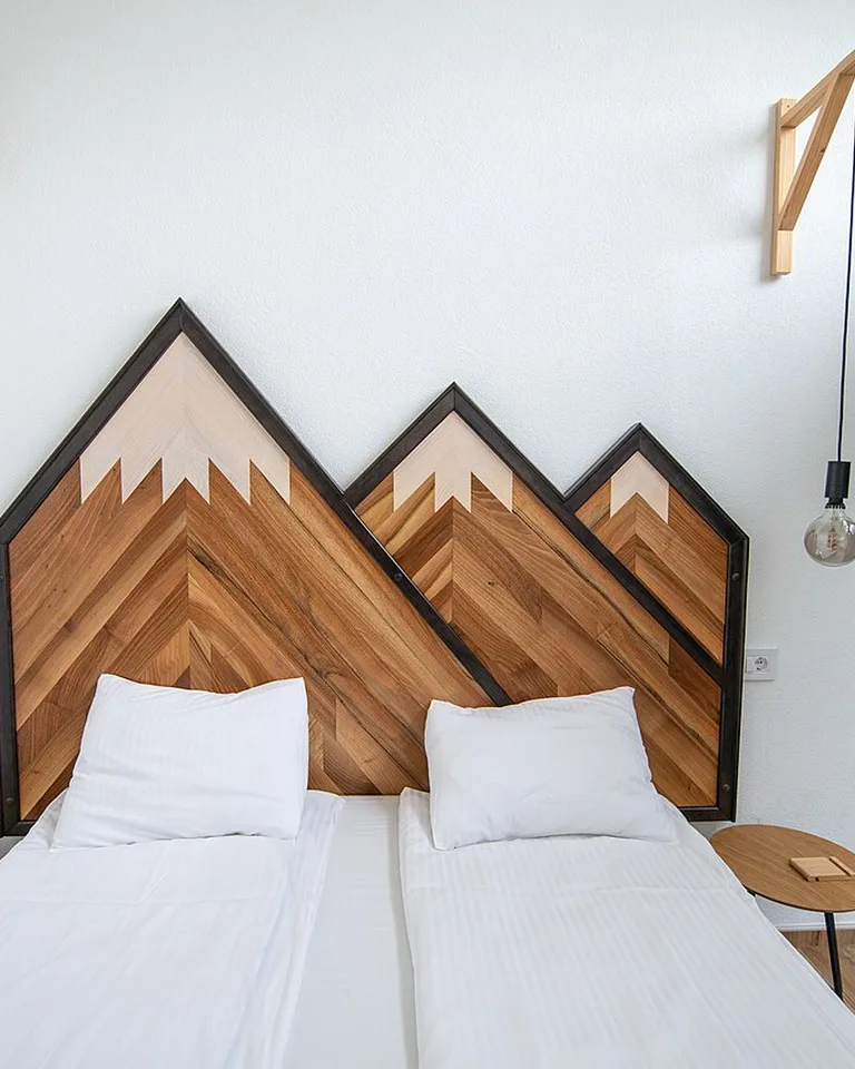 A modern bedroom with a wooden headboard showing how a mirror completes the room