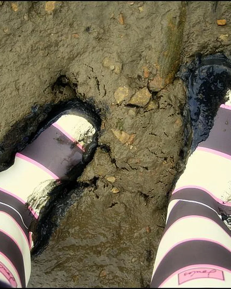 Muddy wellington boots showing why a boot tray zone matters