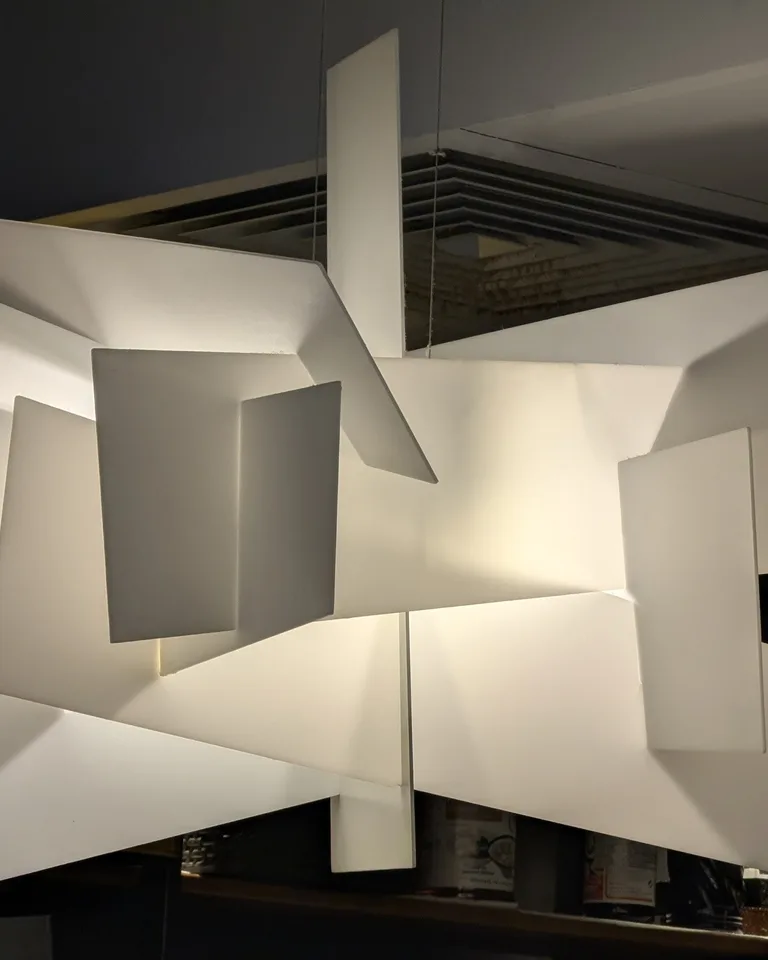 Geometric white pendant lamp hanging from a ceiling