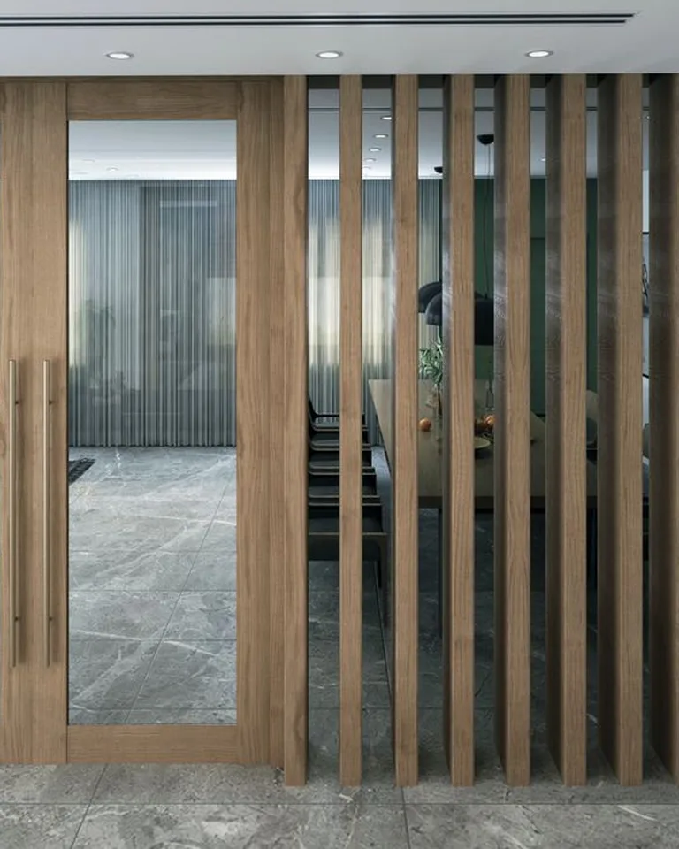 A slatted wooden room divider standing near a front door entry