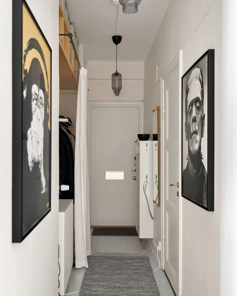 A warm pendant light fixture glowing above an entry console area