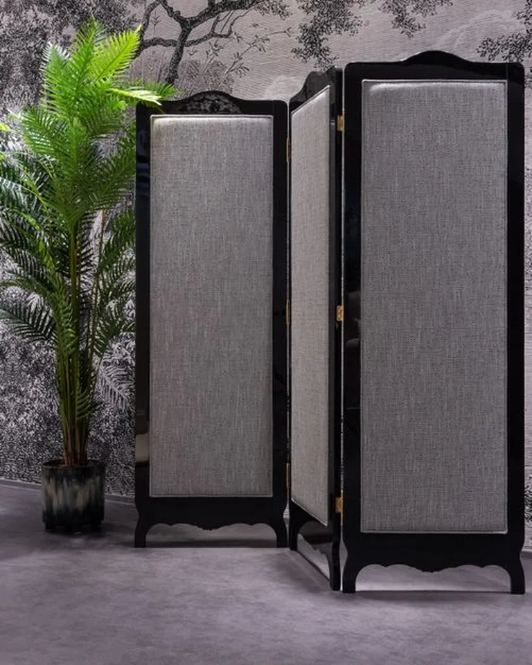 A freestanding folding room divider screen in a living space