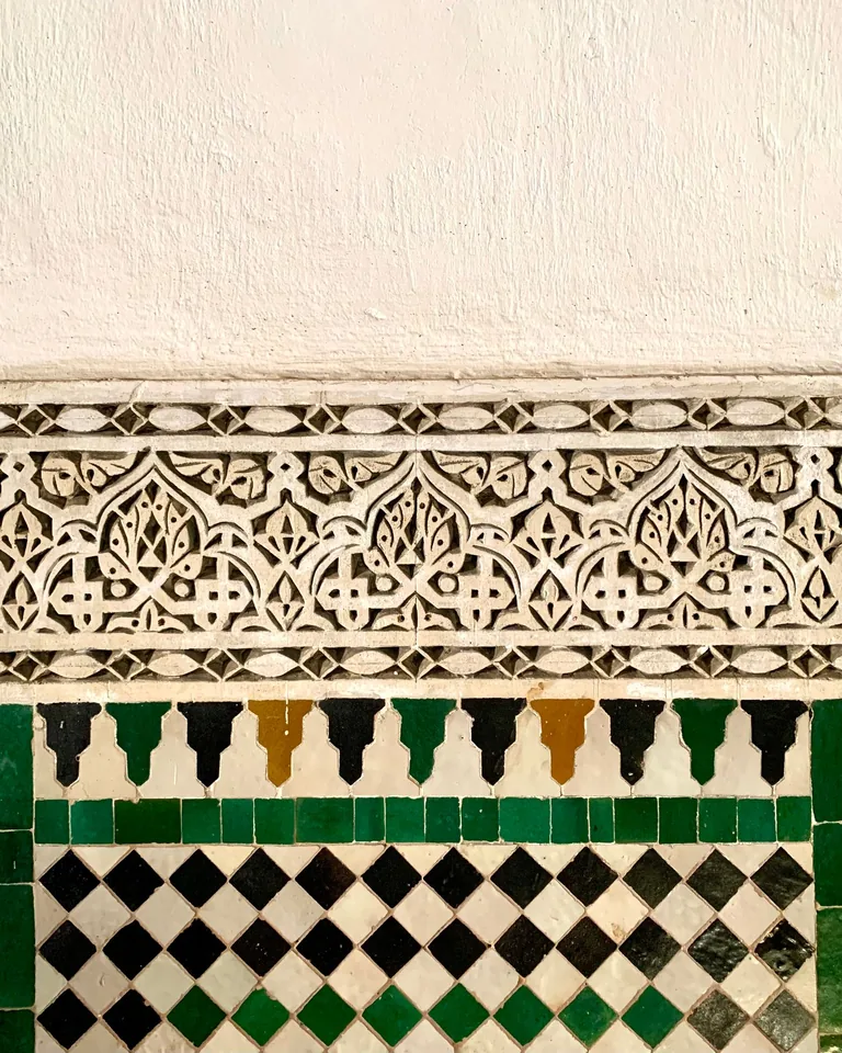 Ornate Moroccan-style zellige tile wall in warm neutral tones