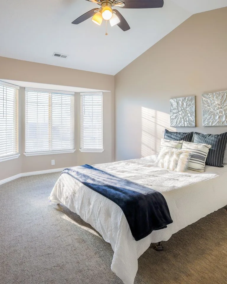 Bedroom with warm beige walls and crisp ivory trim