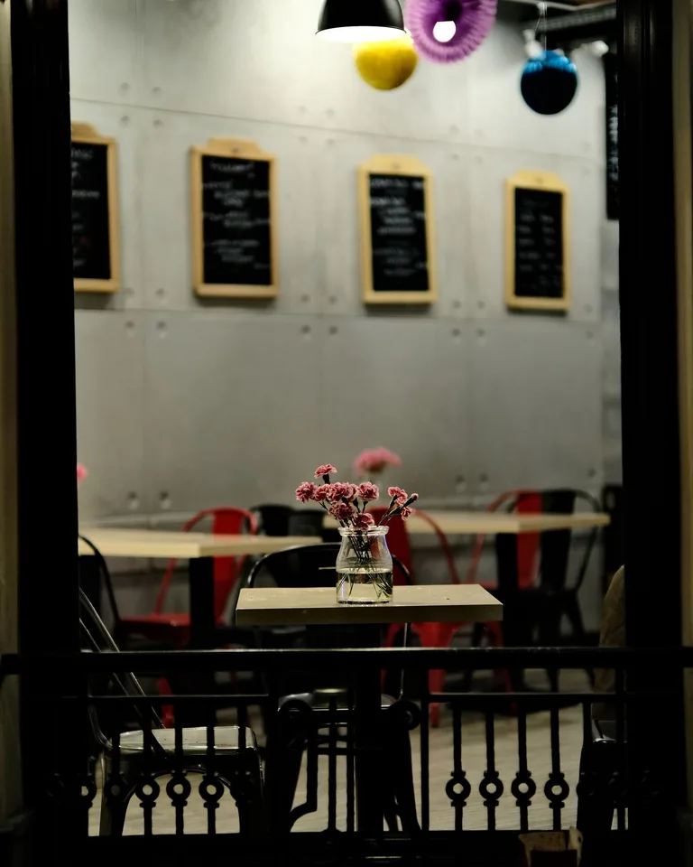 Chic cafe interior with stylish small tables and chairs