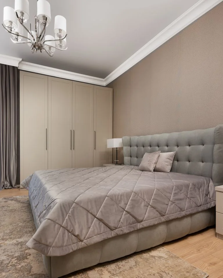 Bedroom painted in soft mushroom beige with neutral decor