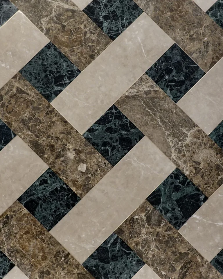 Geometric marble tiles arranged in a herringbone-style pattern