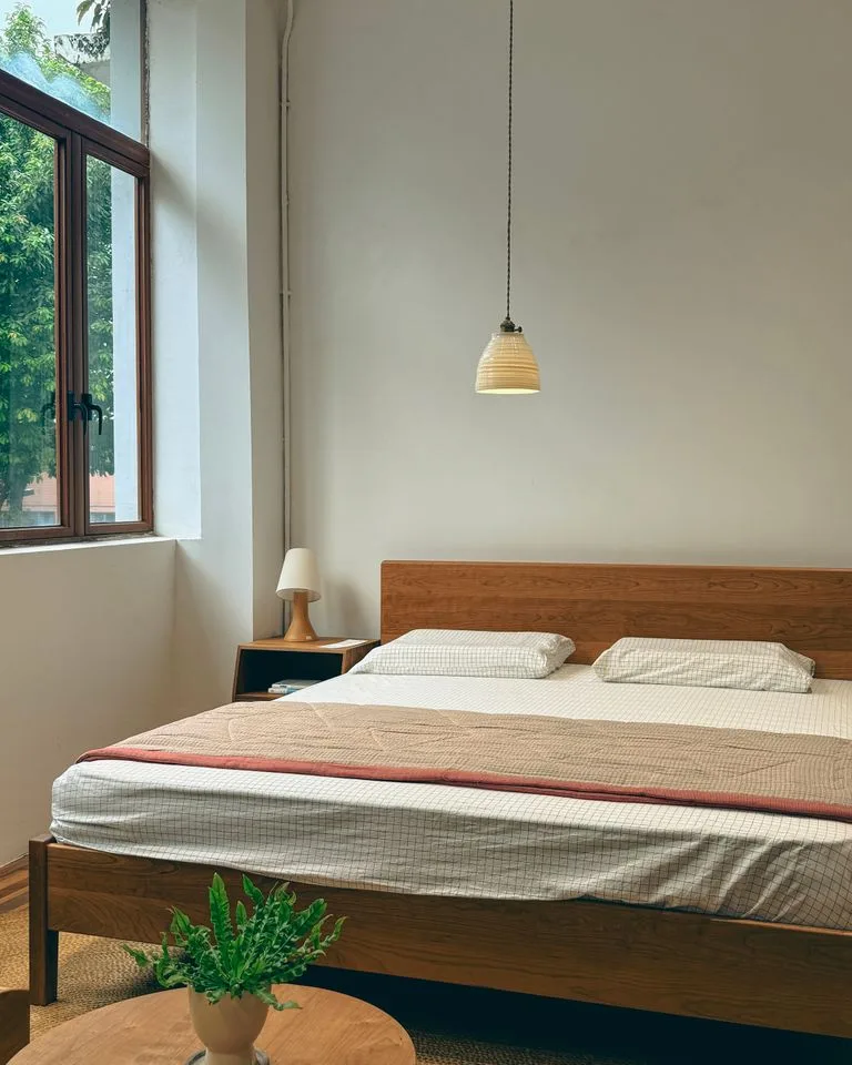 Walnut wood bed frame paired with beige linen bedding