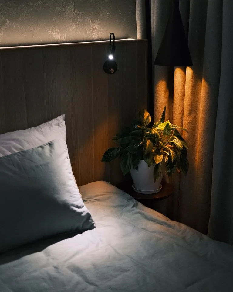 Warm bedside lamp casting a soft glow in a cozy bedroom