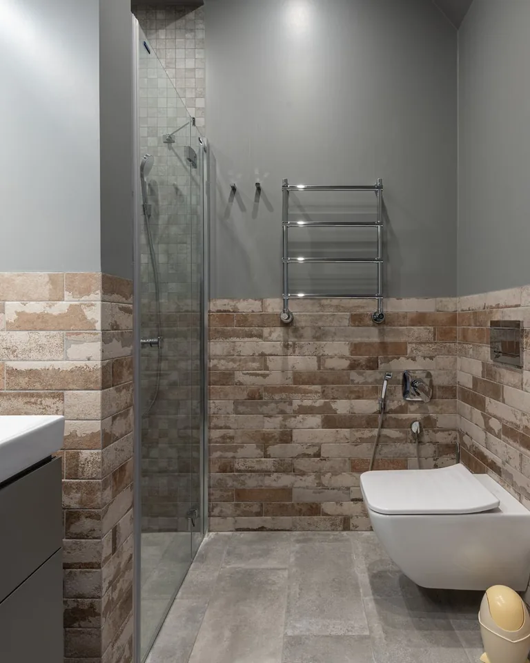 Contemporary bathroom with brick-look tile accent wall
