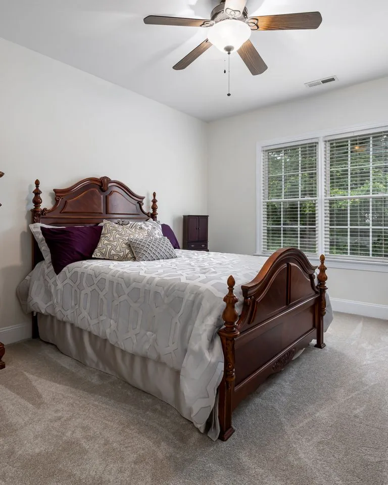 Dark wood furniture contrasting with soft beige bedroom walls
