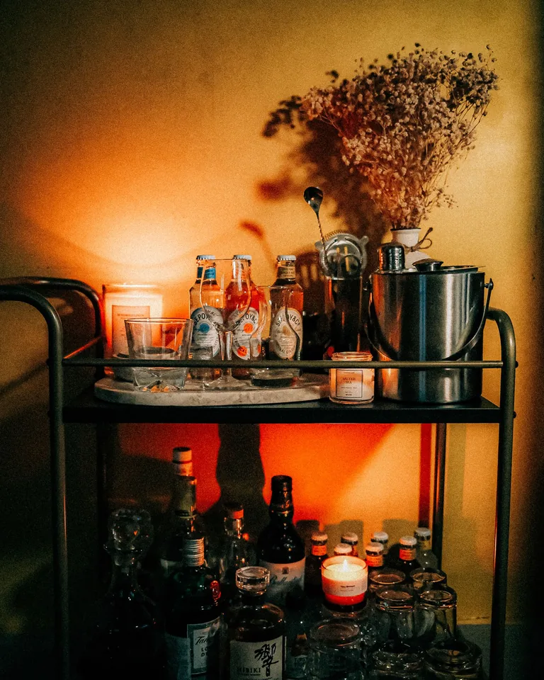 Elegant boho-style bar cart with warm ambient lighting