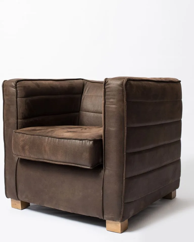 Cognac leather armchair in a warm beige bedroom
