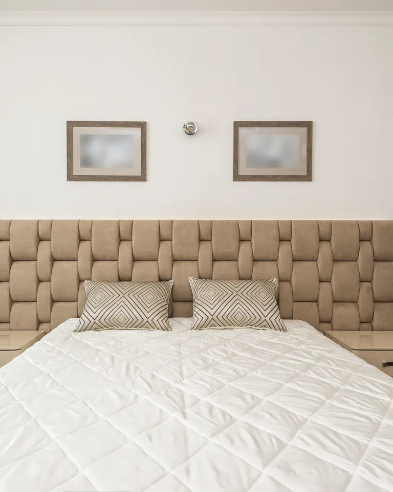 Bed centered on the main bedroom wall with matching nightstands on each side