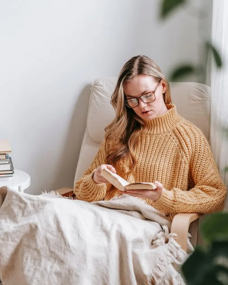 Cozy reading nook with an armchair beside the bedroom window