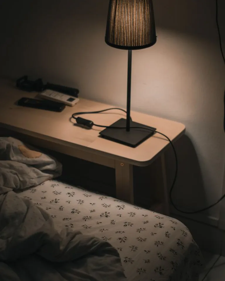 Matching nightstands with table lamps flanking a French country bed