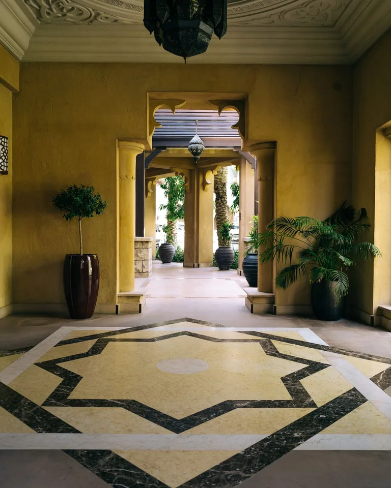 A tidy entryway with hooks, baskets, and a washable runner