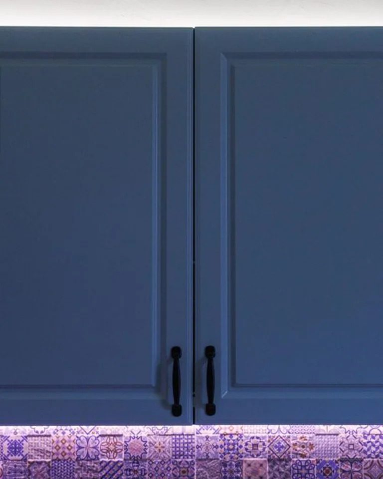 Warm under-cabinet lighting glowing over a coffee station at night